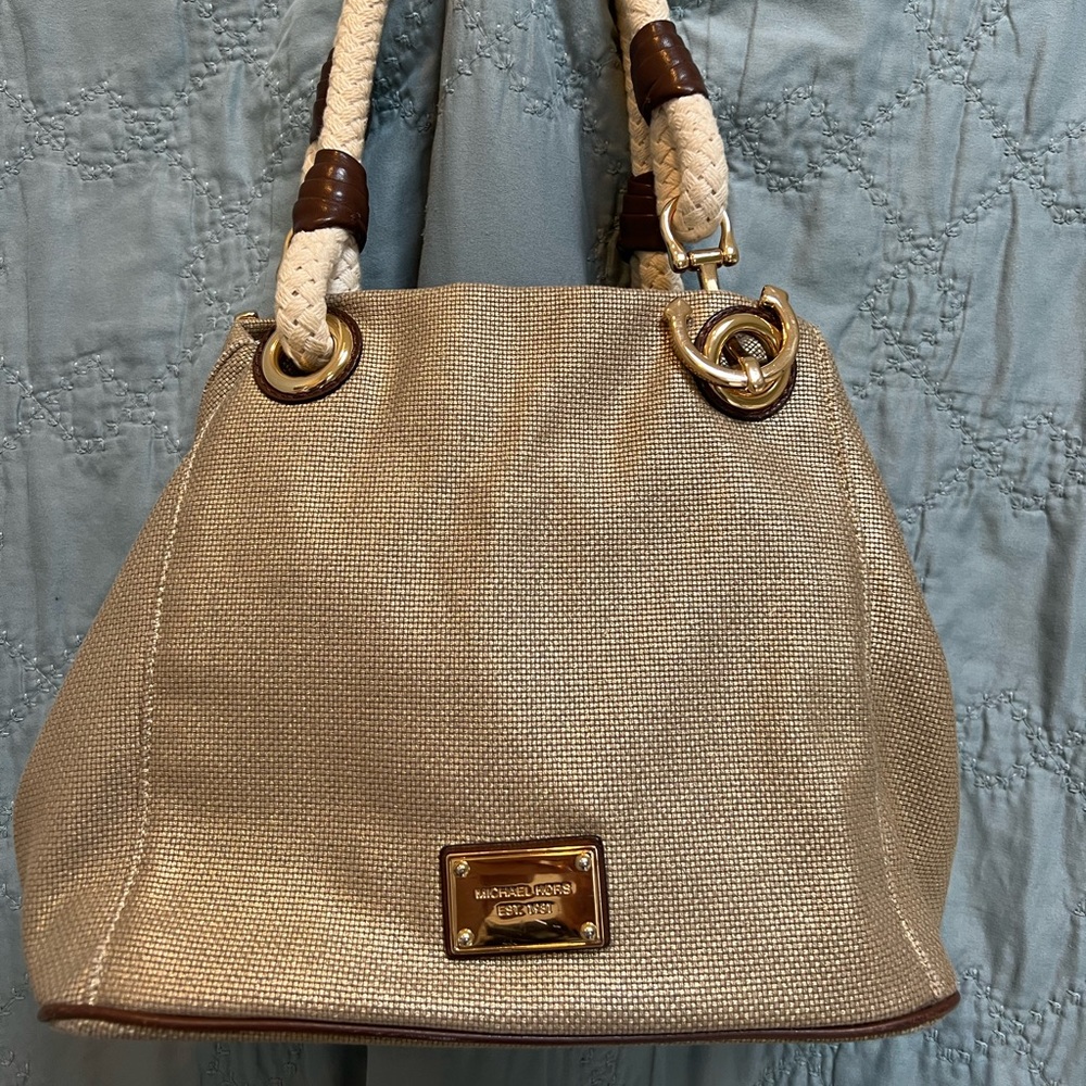 Michael Kors Marina tote in gold canvas with brown leather trim.